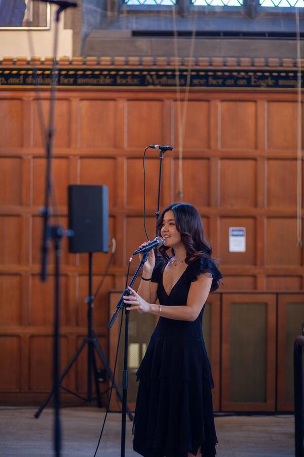 A guest vocalist performing at Love of the Season, March 2026